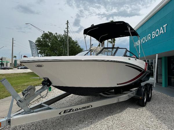 Slide: The Image of 2018 Glastron GTD 200 boat on EZ Loader trailer outside dealership. - 0