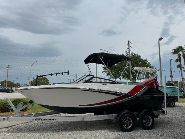 Slide: The Image of 2018 Glastron GTD 200 boat on a trailer with a black canopy. - 1