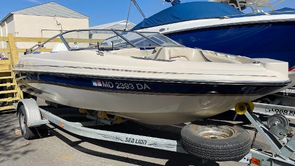 Slide: The Image of 2003 Glastron GX 180 Ski & Fish boat on a trailer in a marina. - 1