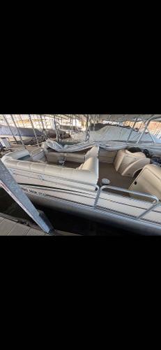 Slide: The Image of 2005 Godfrey AquaPatio 240 LE pontoon boat with beige seating, docked in a marina. - 10