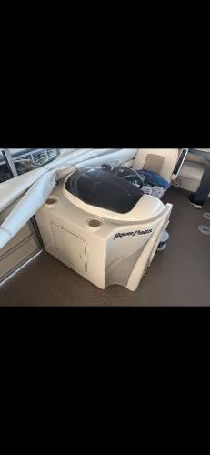 Slide: The Image of 2005 Godfrey AquaPatio 240 LE boat interior with seating and storage. - 17