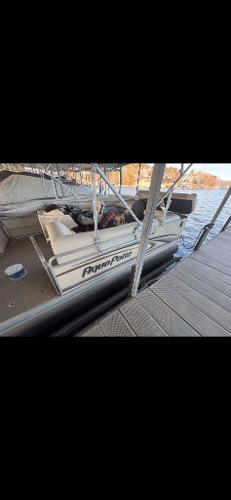 Slide: The Image of 2005 Godfrey AquaPatio 240 LE pontoon boat docked by the water. - 8