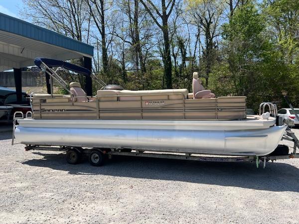 Slide: The Image of 2008 Godfrey SANPAN 2500 DC pontoon boat on trailer, parked outdoors. - 0