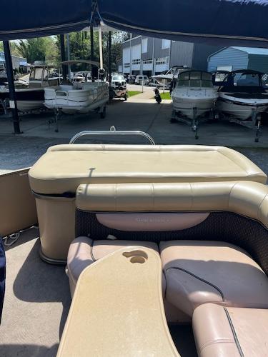 Slide: The Image of 2008 Godfrey SANPAN 2500 DC pontoon boat interior with seating and storage, docked in a marina. - 10
