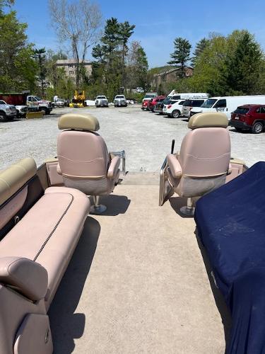 Slide: The Image of 2008 Godfrey SANPAN 2500 DC pontoon boat interior with seating, parked in a lot. - 13