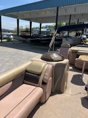 Slide: The Image of 2008 Godfrey SANPAN 2500 DC pontoon boat with beige seating, docked under a covered area. - 16