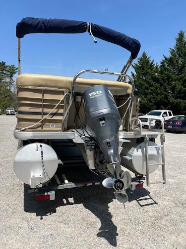 Slide: The Image of 2008 Godfrey SANPAN 2500 DC pontoon boat with outboard motor, parked on a trailer. - 2