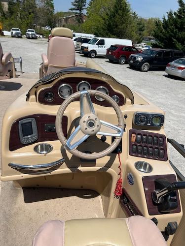 Slide: The Image of 2008 Godfrey SANPAN 2500 DC boat dashboard with steering wheel and control panel. - 3