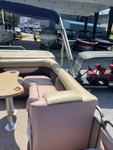 Slide: The Image of 2008 Godfrey SANPAN 2500 DC pontoon boat with seating and table, docked in a marina. - 9