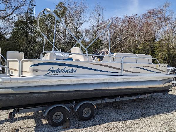 Slide: The Image of 2006 Godfrey Sweetwater pontoon boat on trailer, parked outdoors. - 1