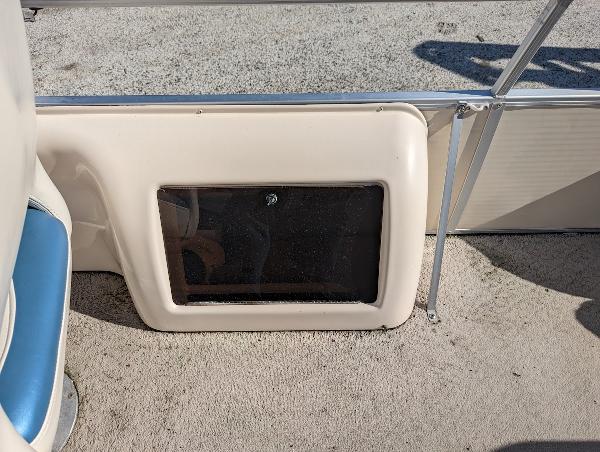 Slide: The Image of 2006 Godfrey Sweetwater boat interior with beige panel and window. - 10