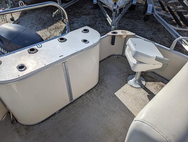 Slide: The Image of 2006 Godfrey Sweetwater boat interior with seating and storage compartments. - 14