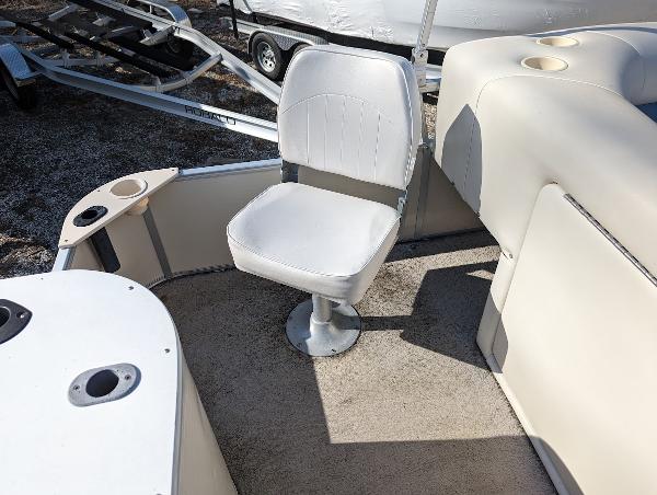 Slide: The Image of 2006 Godfrey Sweetwater boat interior with swivel chair and cup holders. - 15