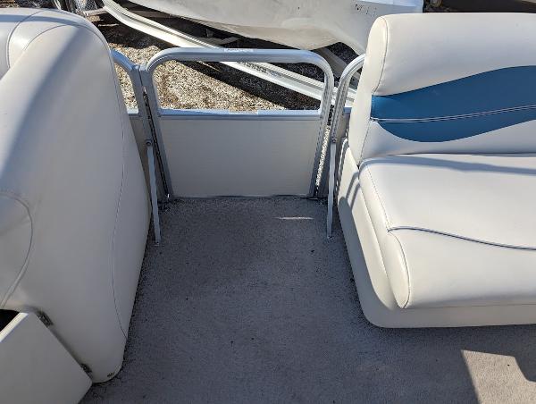 Slide: The Image of 2006 Godfrey Sweetwater boat interior with white and blue seating. - 17