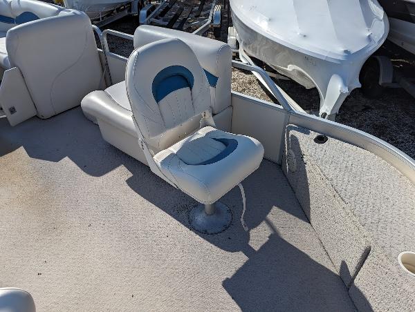 Slide: The Image of 2006 Godfrey Sweetwater boat interior with white and blue seating. - 21