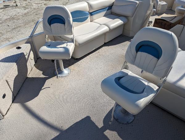 Slide: The Image of 2006 Godfrey Sweetwater boat interior with white and blue seating. - 22