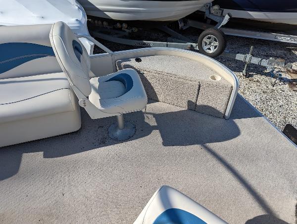 Slide: The Image of 2006 Godfrey Sweetwater boat interior with seating and carpeted deck. - 23