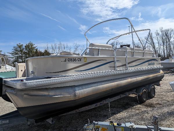 Slide: The Image of 2006 Godfrey Sweetwater pontoon boat on trailer under clear sky. - 7
