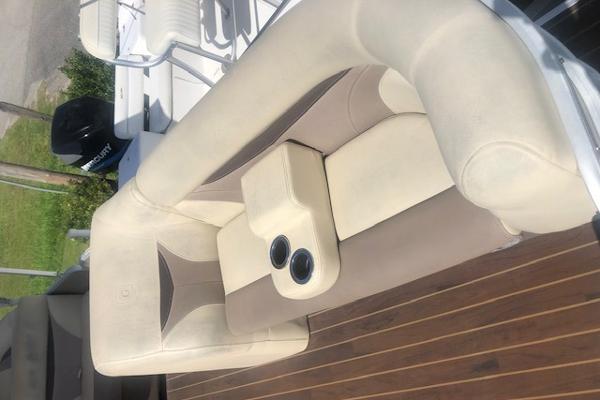 Slide: The Image of 2018 Godfrey Sweetwater 2286C boat seating with cup holders on wooden deck. - 6