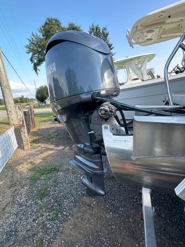 Slide: The Image of 2025 Godfrey SWEETWATER 2286 SB with Yamaha outboard motor, parked on gravel. - 12