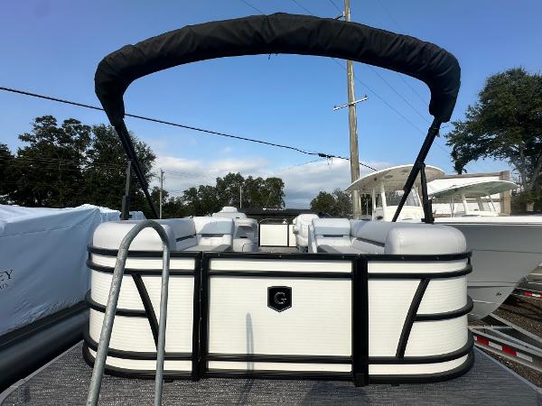 Slide: The Image of 2025 Godfrey SWEETWATER 2286 SB pontoon boat with canopy, docked outdoors. - 13