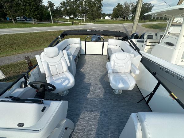 Slide: The Image of 2025 Godfrey SWEETWATER 2286 SB pontoon boat with luxurious white seating and spacious deck. - 15