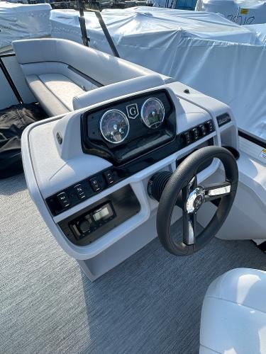 Slide: The Image of 2025 Godfrey SWEETWATER 2286 SB boat dashboard with steering wheel and gauges. - 17