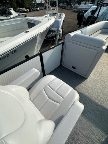 Slide: The Image of 2025 Godfrey SWEETWATER 2286 SB boat interior with white seating and deck view. - 19