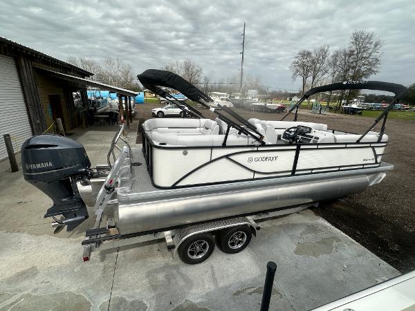 Slide: The Image of 2025 Godfrey SWEETWATER 2286 SB pontoon boat on trailer, featuring Yamaha outboard motor. - 22