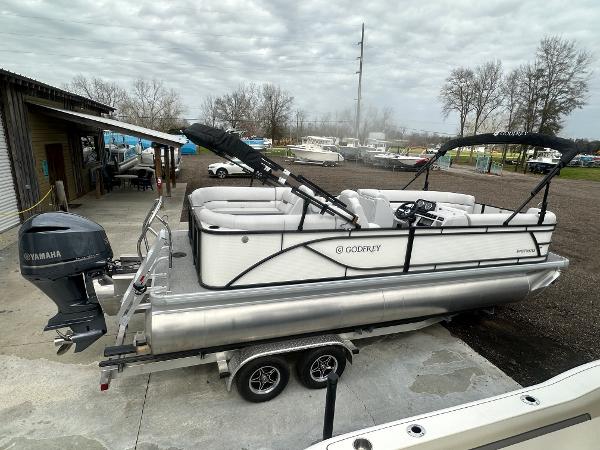 Slide: The Image of 2025 Godfrey SWEETWATER 2286 SB pontoon boat on trailer, Yamaha motor, outdoor setting. - 23