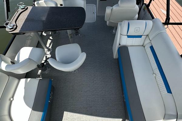 Slide: The Image of 2022 Godfrey Sw Mid Table Tri-Toon interior with seating and table. - 6
