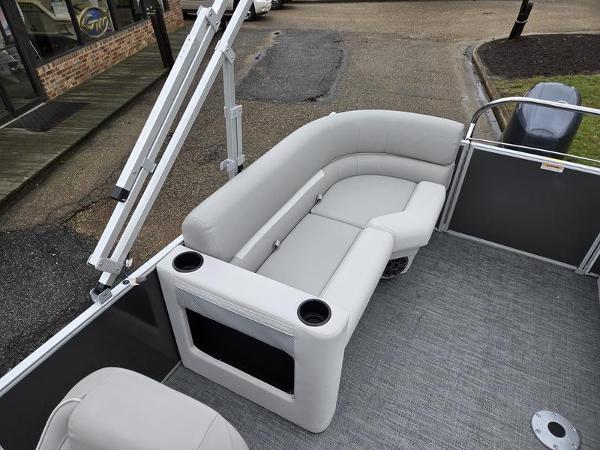 Slide: The Image of 2024 Godfrey Xperience 2286 SBX pontoon boat interior with gray seating and cup holders. - 10