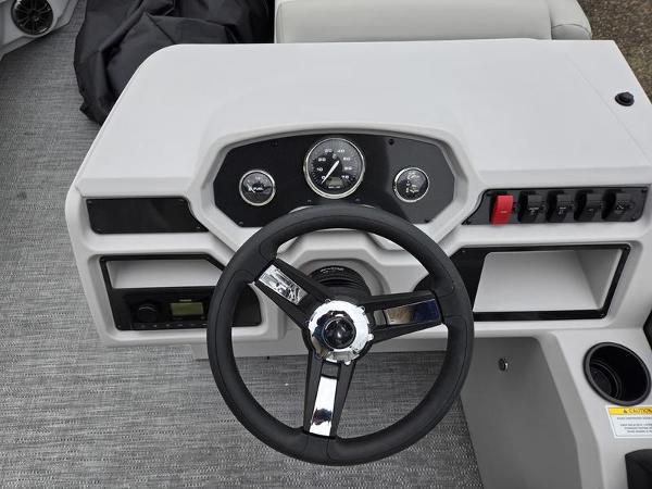 Slide: The Image of 2024 Godfrey Xperience 2286 SBX boat dashboard with steering wheel and control panel. - 8