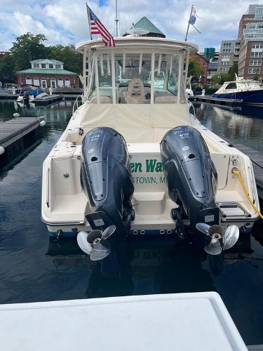 Slide: The Image of 2020 Grady-White 330 Express boat docked with twin outboard engines. - 2