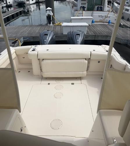 Slide: The Image of 2020 Grady-White 330 Express boat docked, showing spacious deck and twin outboard engines. - 4