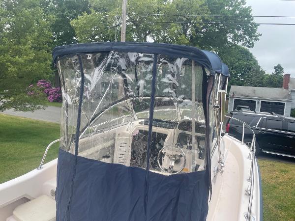 Slide: The Image of 1998 Grady-White Adventure 208 boat with blue canopy, parked outdoors. - 18