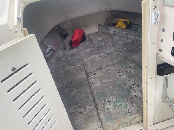 Slide: The Image of Interior cabin of 1998 Grady-White Adventure 208 boat with patterned flooring and storage items. - 19