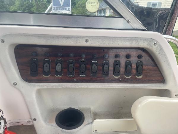 Slide: The Image of Control panel of a 1998 Grady-White Adventure 208 boat with multiple switches. - 9