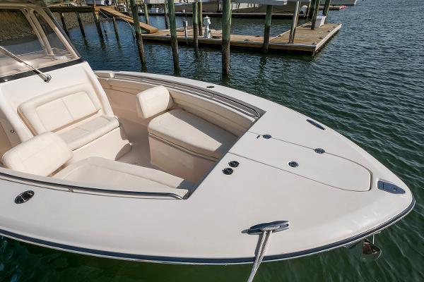 Slide: The Image of Manufacturer Provided Image: 2019 Grady-White Canyon 306 boat with spacious seating at the bow, docked in calm waters. - 5