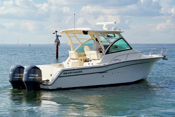 Slide: The Image of 2016 Grady-White Express 330 boat on water with twin Yamaha engines. - 1
