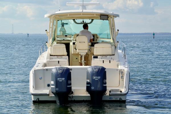 Slide: The Image of 2016 Grady-White Express 330 boat with dual engines on open water. - 13