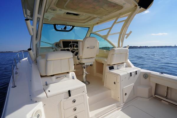 Slide: The Image of 2016 Grady-White Express 330 boat interior with helm, seating, and ocean view. - 14