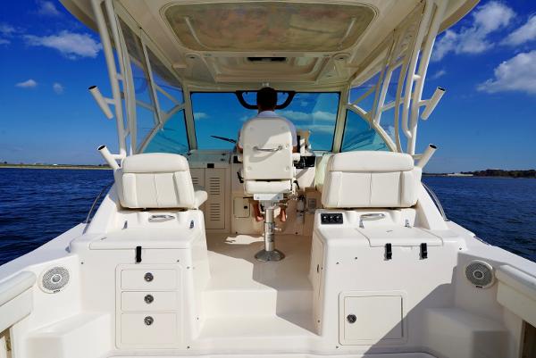 Slide: The Image of 2016 Grady-White Express 330 boat interior with helm, white seating, and ocean view. - 15