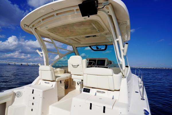 Slide: The Image of 2016 Grady-White Express 330 boat interior with helm, white seating, and ocean view. - 16