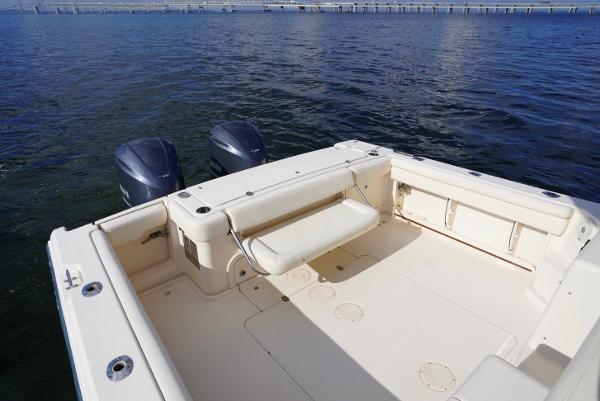 Slide: The Image of 2016 Grady-White Express 330 boat deck with dual outboard motors on calm water. - 20