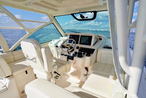 Slide: The Image of 2016 Grady-White Express 330 boat interior with helm, steering wheel, and navigation screens. - 35