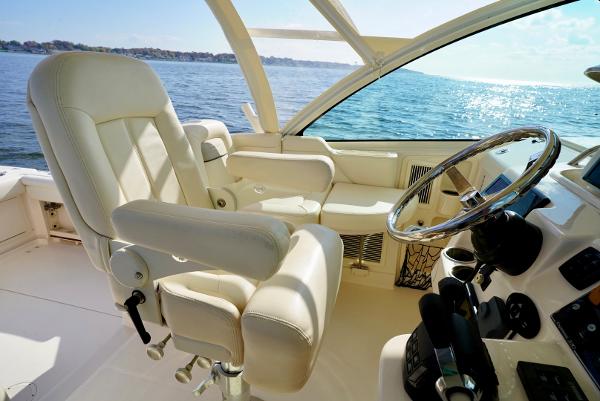 Slide: The Image of Luxurious 2016 Grady-White Express 330 boat interior with captain's chair and steering wheel. - 36