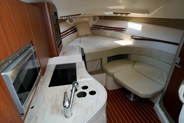Slide: The Image of 2016 Grady-White Express 330 interior with kitchen, seating, and bed. - 38