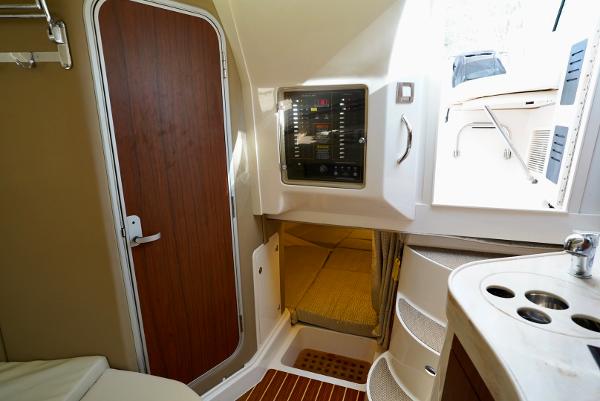 Slide: The Image of 2016 Grady-White Express 330 cabin interior with control panel and wooden door. - 39