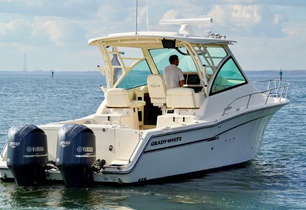 Slide: The Image of 2016 Grady-White Express 330 boat with twin Yamaha engines on open water. - 8